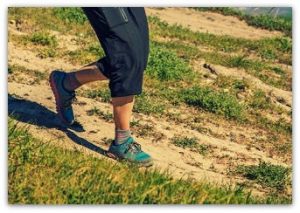 Running...Photo of a Trail Runner's Legs Running Down a Hill